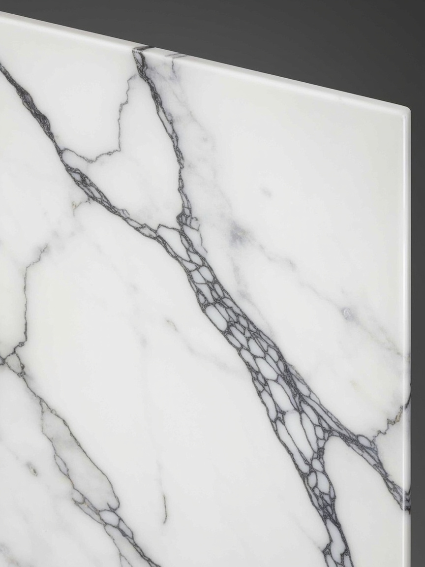 Statuario marble slab: bright pure white background with bold, dramatic grey veining — premium Italian marble